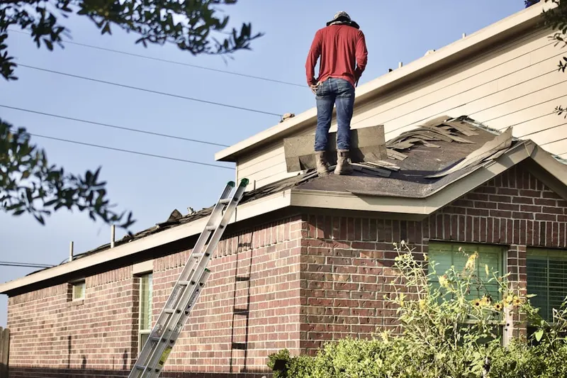 Professional roofer working on a residential roof in Springwells